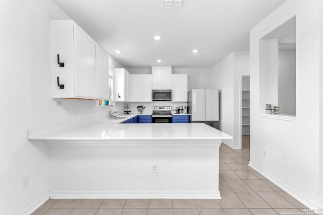 15836 Selene, San Antonio, TX 78245 - kitchen featuring appliances with stainless steel finishes, a sink, light tile patterned floors, light countertops, and recessed lighting