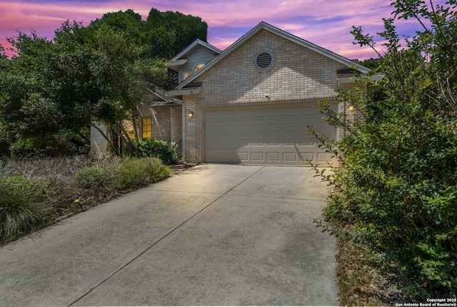 5919 Cedar Path, San Antonio, TX 78249 - view of front facade featuring driveway, an attached garage, and brick siding