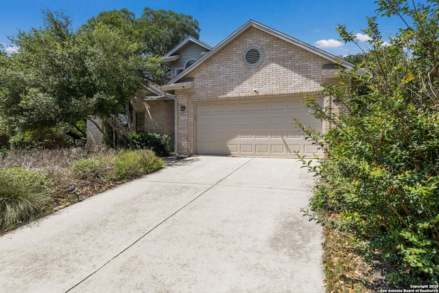 5919 Cedar Path, San Antonio, TX 78249 - view of front of home with an attached garage, concrete driveway, and brick siding
