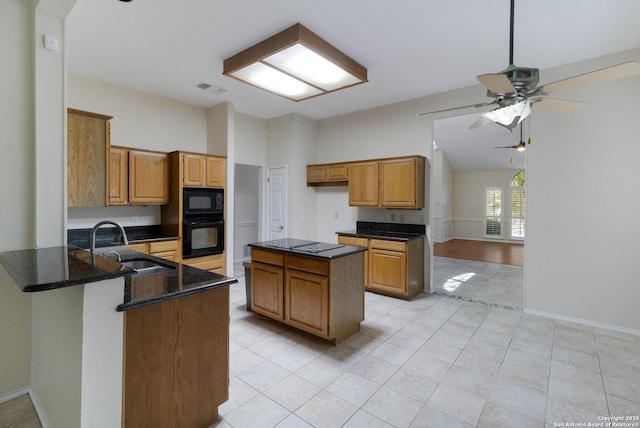 5919 Cedar Path, San Antonio, TX 78249 - kitchen with black appliances, a sink, ceiling fan, dark stone counters, and brown cabinets
