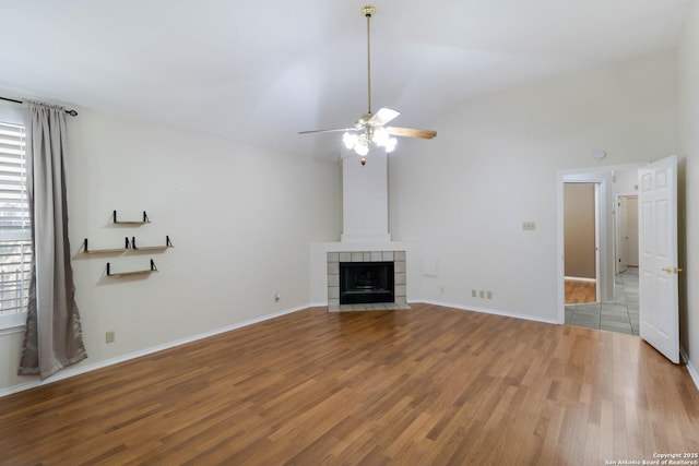 5919 Cedar Path, San Antonio, TX 78249 - unfurnished living room with light wood-style floors, ceiling fan, lofted ceiling, a fireplace, and baseboards