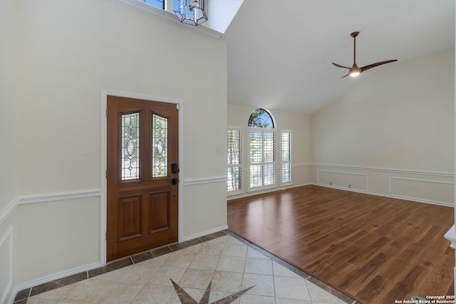 5919 Cedar Path, San Antonio, TX 78249 - foyer featuring high vaulted ceiling, a wainscoted wall, ceiling fan, light tile patterned floors, and inlaid floor details