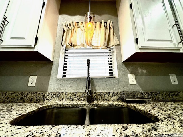1239 Kayton, San Antonio, TX 78210 - kitchen view of a sink, white cabinetry, dark stone counters, and pendant lighting