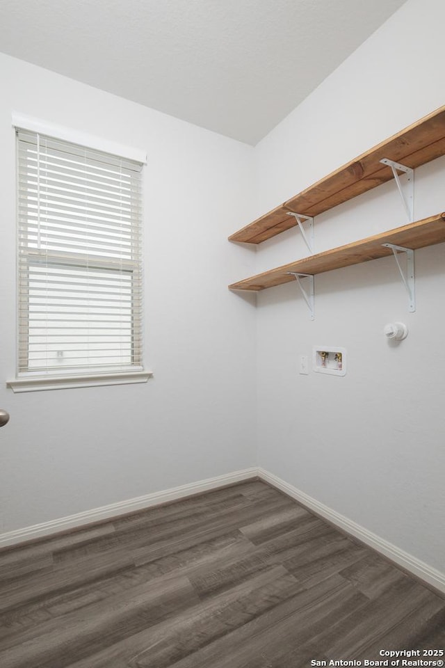 clothes washing area featuring hookup for a washing machine, dark wood finished floors, and baseboards