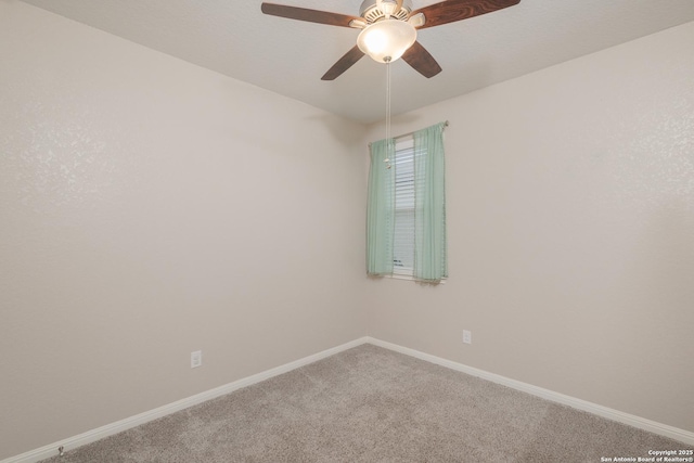 empty room with carpet flooring, baseboards, and a ceiling fan