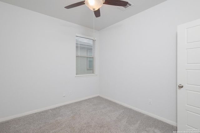 empty room with carpet, a ceiling fan, and baseboards