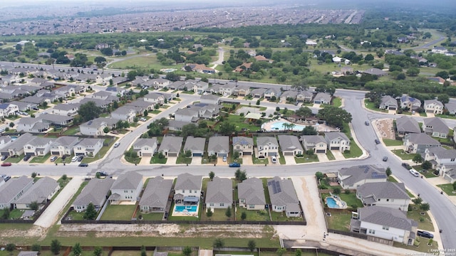 aerial view of property's location with nearby suburban area and a pool area