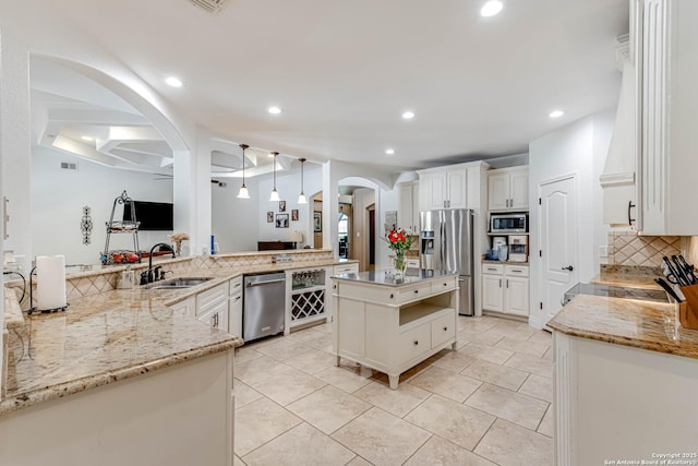 515 County Road 3822, San Antonio, TX 78253 - kitchen with appliances with stainless steel finishes, a sink, arched walkways, tasteful backsplash, and recessed lighting