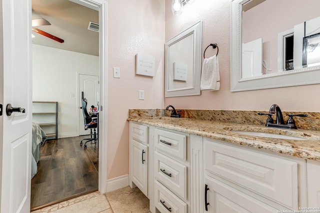 515 County Road 3822, San Antonio, TX 78253 - bathroom featuring double vanity, ceiling fan, and baseboards