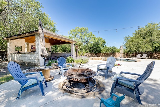 515 County Road 3822, San Antonio, TX 78253 - view of patio featuring a fire pit and a fenced backyard