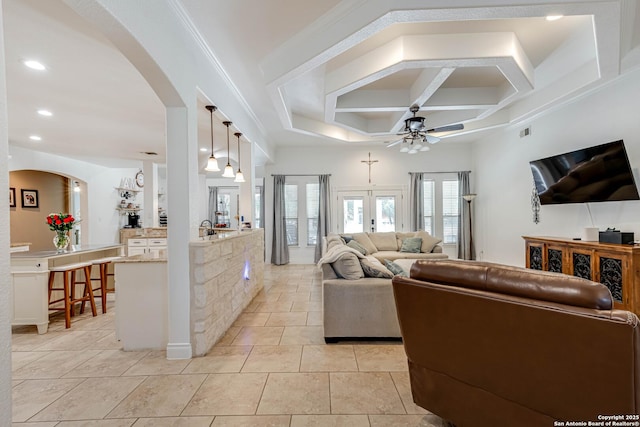 515 County Road 3822, San Antonio, TX 78253 - living room featuring arched walkways, ceiling fan, coffered ceiling, light tile patterned floors, and recessed lighting