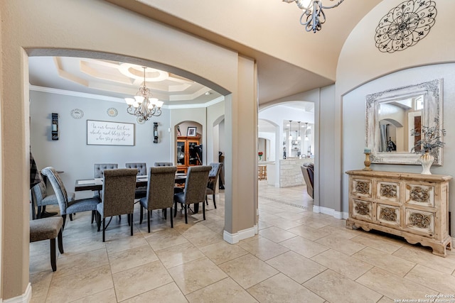 515 County Road 3822, San Antonio, TX 78253 - dining room featuring a chandelier, arched walkways, a tray ceiling, ornamental molding, and baseboards