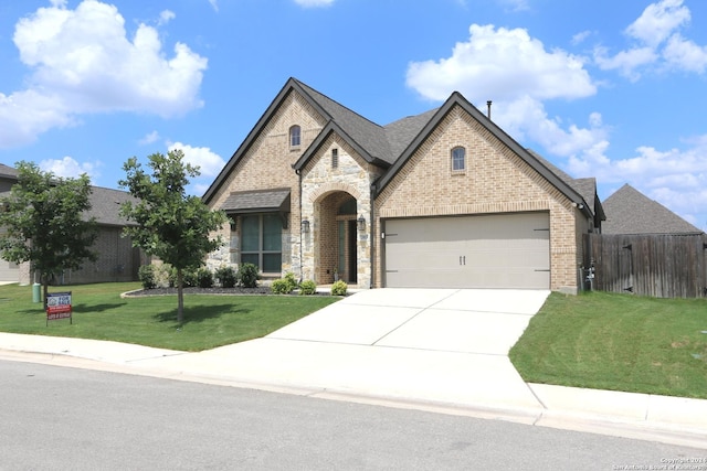 2965 Grove Way, Seguin, TX 78155 - french country inspired facade featuring driveway, a garage, brick siding, and stone siding