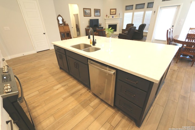 2965 Grove Way, Seguin, TX 78155 - kitchen featuring a sink, stainless steel dishwasher, light wood finished floors, and light countertops