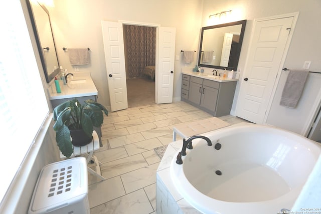 2965 Grove Way, Seguin, TX 78155 - bathroom with marble finish floors, a garden tub, and two vanities
