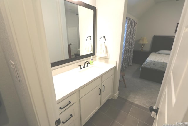 2965 Grove Way, Seguin, TX 78155 - ensuite bathroom with vanity, vaulted ceiling, and tile patterned flooring