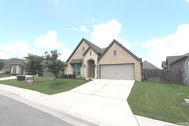 2965 Grove Way, Seguin, TX 78155 - french country inspired facade featuring an attached garage, concrete driveway, brick siding, and stone siding