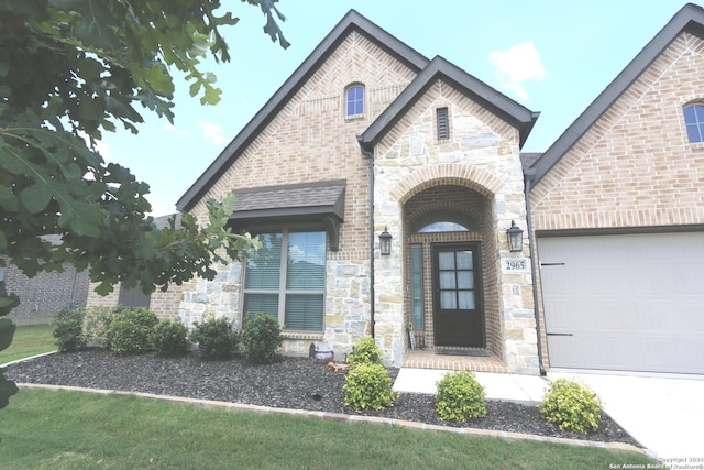 2965 Grove Way, Seguin, TX 78155 - view of front facade featuring stone siding, brick siding, a garage, and driveway
