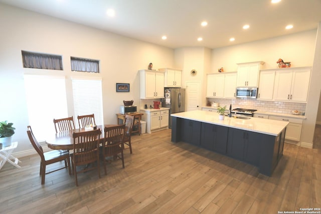2965 Grove Way, Seguin, TX 78155 - kitchen with stainless steel appliances, light countertops, tasteful backsplash, wood finished floors, and recessed lighting