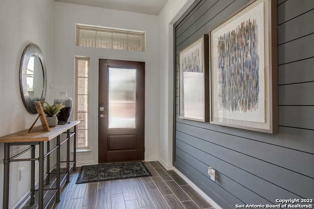 entrance foyer featuring baseboards and wood finish floors