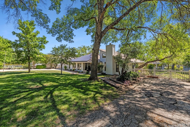 7214 N Vandiver, San Antonio, TX 78209 - view of front of property with roof mounted solar panels, a chimney, and a patio