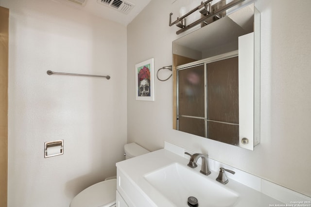 7214 N Vandiver, San Antonio, TX 78209 - bathroom featuring toilet, a shower with shower door, and vanity