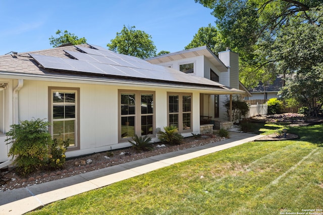 7214 N Vandiver, San Antonio, TX 78209 - view of front facade with roof mounted solar panels, a chimney, and a shingled roof