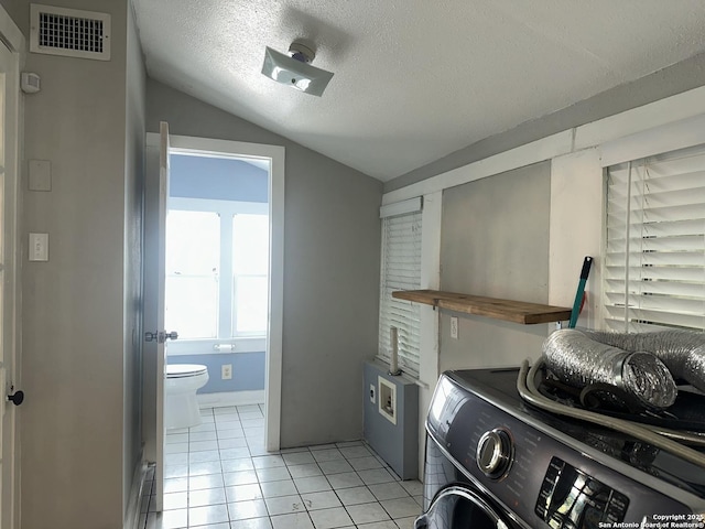 539 Wickes, San Antonio, TX 78210 - laundry area with washer / dryer, light tile patterned floors, and a textured ceiling