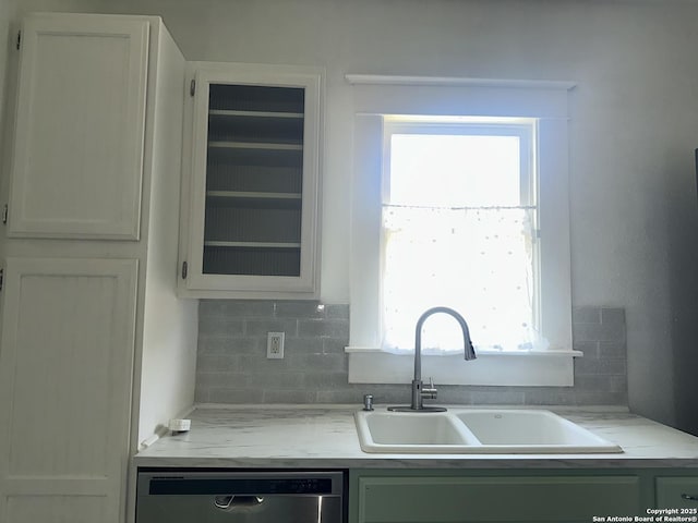 539 Wickes, San Antonio, TX 78210 - kitchen featuring a sink, stainless steel dishwasher, backsplash, glass insert cabinets, and white cabinets