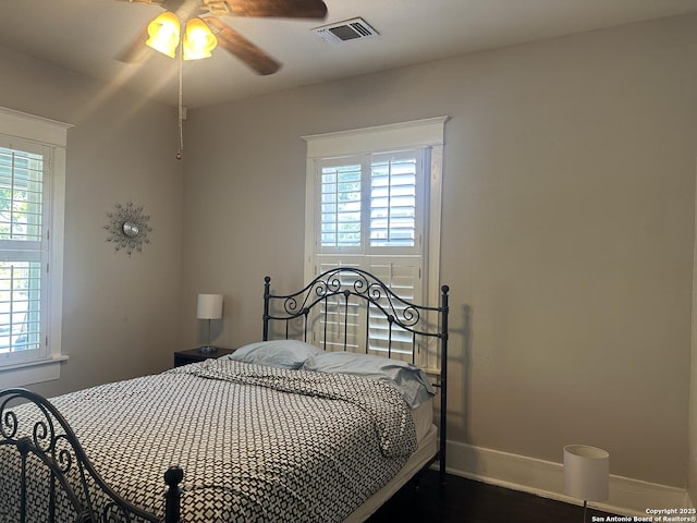 539 Wickes, San Antonio, TX 78210 - bedroom with baseboards, multiple windows, wood finished floors, and ceiling fan