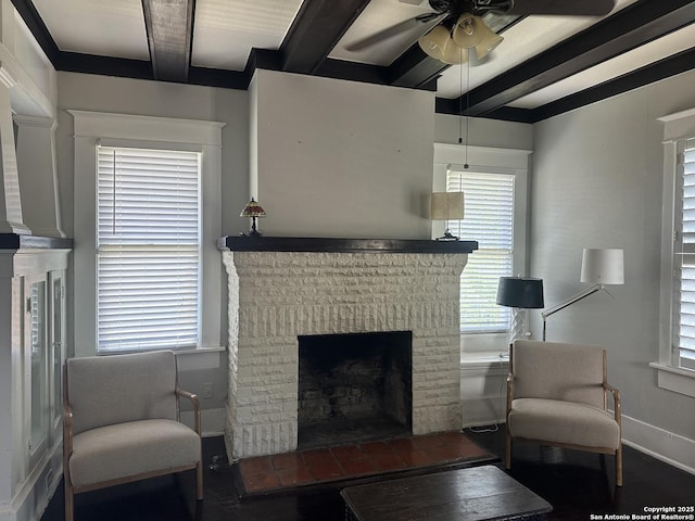 539 Wickes, San Antonio, TX 78210 - living room featuring beamed ceiling, a fireplace, ceiling fan, baseboards, and wood finished floors