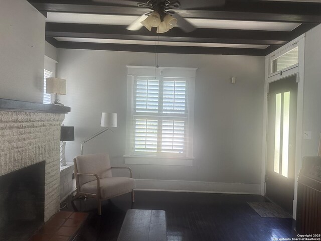 539 Wickes, San Antonio, TX 78210 - unfurnished room featuring beamed ceiling, a fireplace, ceiling fan, wood finished floors, and baseboards