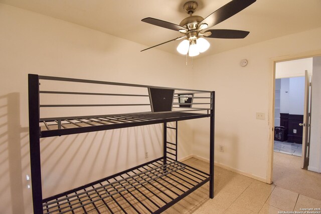 723 Clark Ave, San Antonio, TX 78210 - unfurnished bedroom with baseboards and a ceiling fan