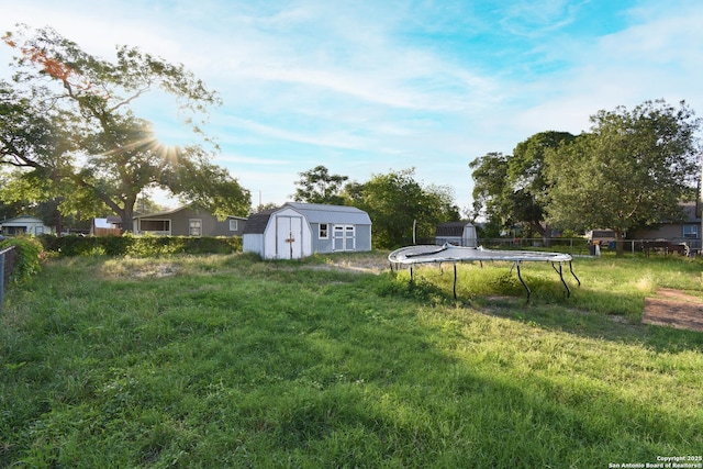 723 Clark Ave, San Antonio, TX 78210 - view of yard featuring a trampoline, a shed, an outbuilding, and fence