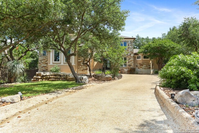 927 Scenic Stroll, San Antonio, TX 78260 - view of property hidden behind natural elements featuring stucco siding and stone siding
