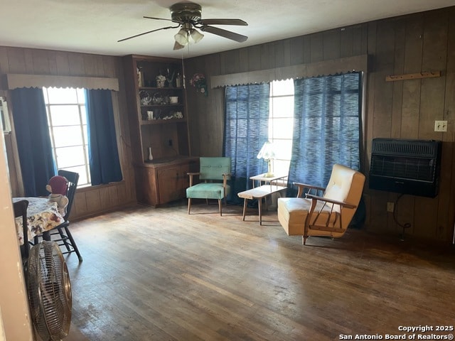 1379 Cedar Elm, New Braunfels, TX 78132 - sitting room featuring wood finished floors, heating unit, wood walls, and a ceiling fan