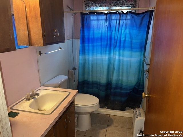 1379 Cedar Elm, New Braunfels, TX 78132 - full bath featuring tile patterned floors, a shower with shower curtain, toilet, radiator, and vanity