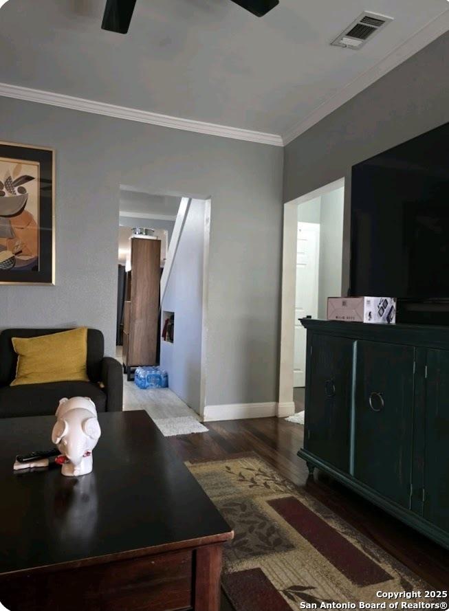 Schertz, TX 78154 - living room with ornamental molding, wood finished floors, and baseboards