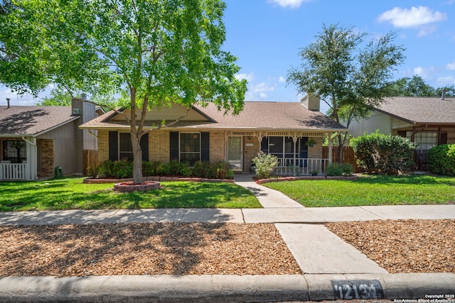 12138 W Lemon Blossom, San Antonio, TX 78247 - view of front of home featuring brick siding, covered porch, and a shingled roof