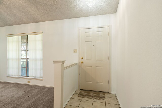 12138 W Lemon Blossom, San Antonio, TX 78247 - doorway to outside with baseboards, light tile patterned floors, and a textured ceiling