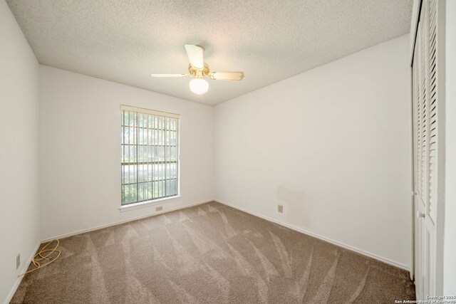 12138 W Lemon Blossom, San Antonio, TX 78247 - unfurnished bedroom with carpet flooring, a textured ceiling, a ceiling fan, baseboards, and a closet