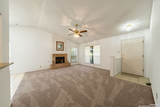 12138 W Lemon Blossom, San Antonio, TX 78247 - unfurnished living room featuring light colored carpet, light tile patterned flooring, ceiling fan, lofted ceiling, and a brick fireplace