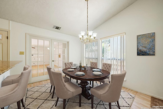 12138 W Lemon Blossom, San Antonio, TX 78247 - dining space with french doors, light wood-type flooring, a chandelier, and lofted ceiling