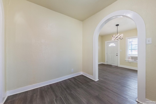 110 Muth, San Antonio, TX 78208 - foyer with arched walkways, dark wood-type flooring, a chandelier, and baseboards
