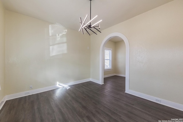 110 Muth, San Antonio, TX 78208 - unfurnished dining area featuring a chandelier, dark wood-style flooring, arched walkways, and baseboards
