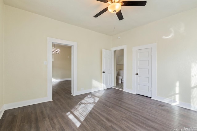 110 Muth, San Antonio, TX 78208 - spare room featuring dark wood-style floors, a ceiling fan, baseboards, and a chandelier