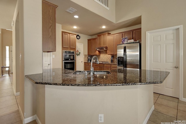 6139 Diego Ln, San Antonio, TX 78253 - kitchen featuring appliances with stainless steel finishes, a sink, light tile patterned floors, under cabinet range hood, and recessed lighting