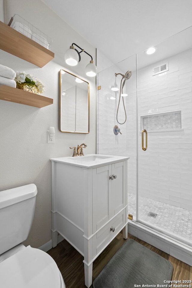 2827 Bent Bow, San Antonio, TX 78209 - full bathroom with toilet, a stall shower, wood finished floors, and vanity