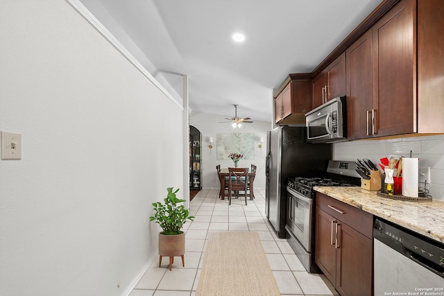 2827 Bent Bow, San Antonio, TX 78209 - kitchen with stainless steel appliances, ceiling fan, light tile patterned floors, light stone counters, and decorative backsplash