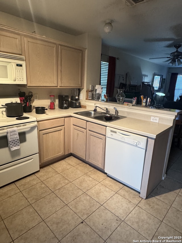 61 Autumn Pass Unit 0, San Antonio, TX 78245 - kitchen with white appliances, a sink, a peninsula, light tile patterned flooring, and light countertops